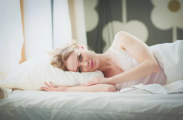 Güzel bir kadın yatağında uzanıyor.. — Stok fotoğraf