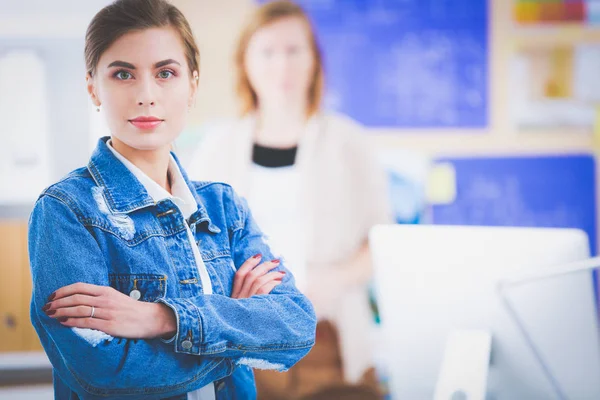 机の近くに楽器と計画とノートパソコンを持った二人の若い女性. — ストック写真