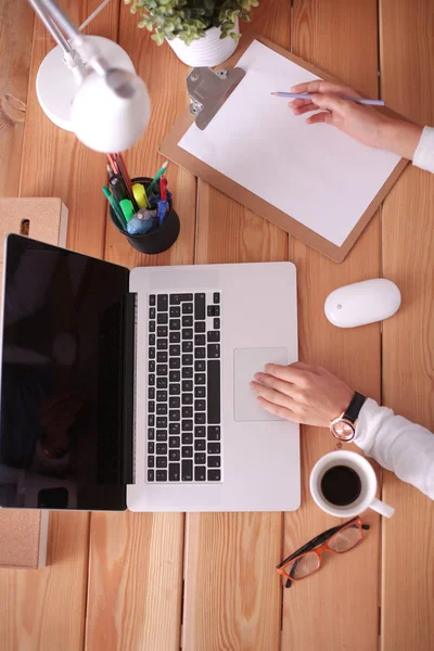 Jonge vrouw werkend zittend aan een bureau. — Stockfoto