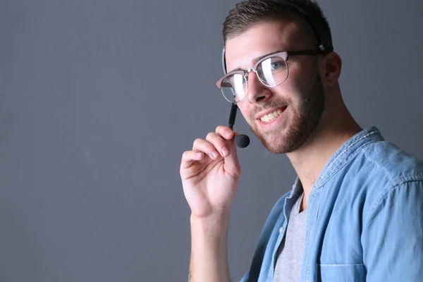 Portrait of young male with microphone. Call-center assistant. H — Stock Photo, Image