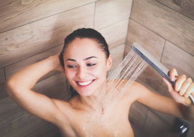 Genç beautyful kadın banyoda duş altında.