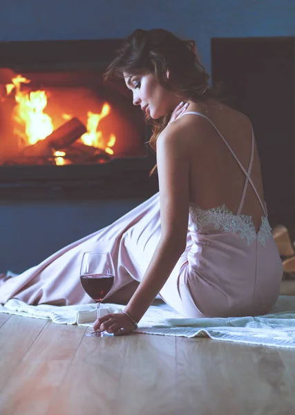 Sexy woman in front of the fireplace. Wood fireplace. — Stock Photo, Image