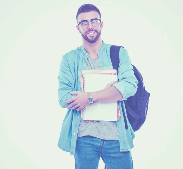 Un estudiante masculino con una bolsa de la escuela sosteniendo libros aislados sobre fondo blanco — Foto de Stock