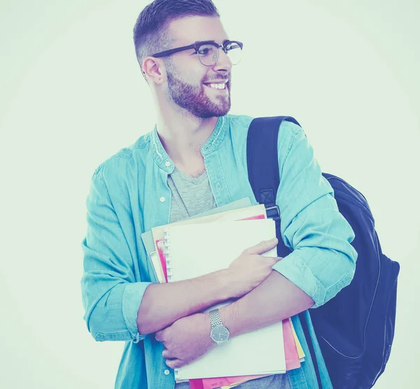 En manlig student med en väska håller böcker isolerad på vit bakgrund — Stockfoto