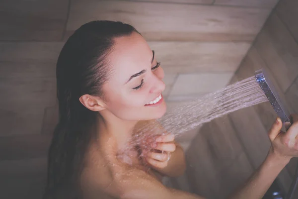 Joven mujer hermosa bajo la ducha en el baño . —  Fotos de Stock