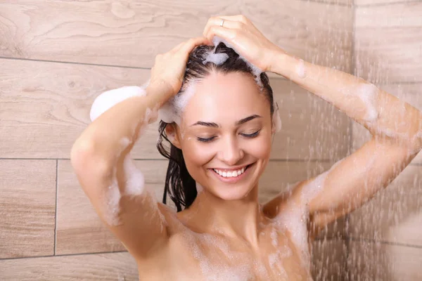 Jovem mulher bonita sob o chuveiro no banheiro . — Fotografia de Stock