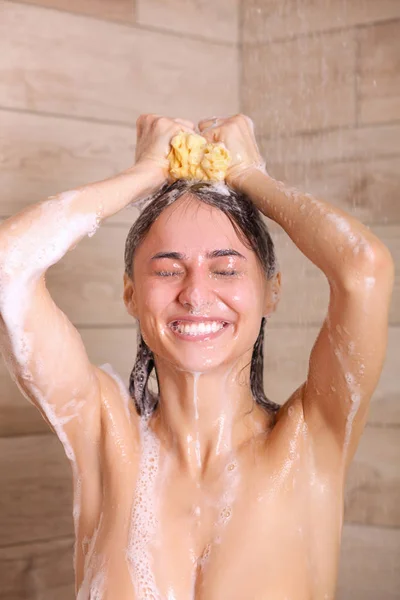Joven mujer hermosa bajo la ducha en el baño . —  Fotos de Stock