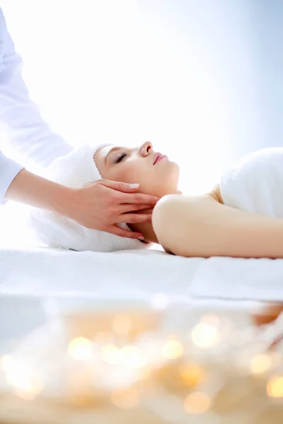 Young woman lying on a massage table,relaxing with eyes closed. Woman. Spa salon — Stock Photo, Image