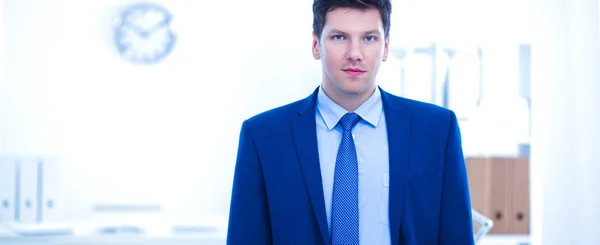 Successful business young man standing in office — Stock Photo, Image