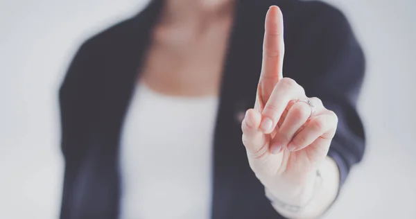 Vrouw die een denkbeeldig scherm met haar vinger aanraakt - geïsoleerd — Stockfoto