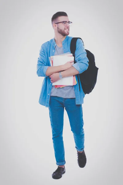 Ученик со школьной сумкой, держащий книги на белом фоне. Образовательные возможности. Студент . — стоковое фото