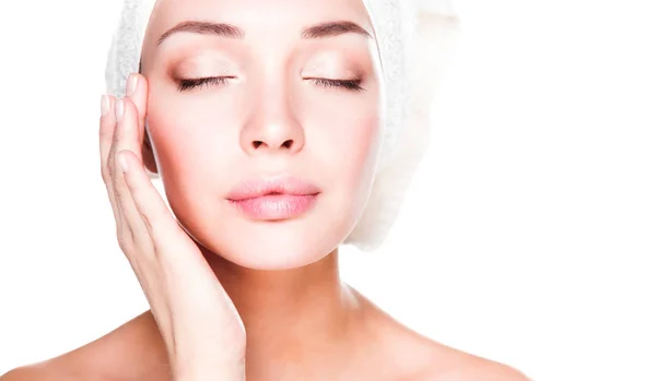 Portrait of beautiful girl touching her face with a towel on  head — Stock Photo, Image