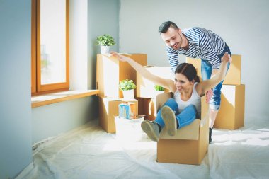 Açma veya kutu ambalaj ve yeni evine taşıdıktan mutlu genç bir çift. Genç Çift