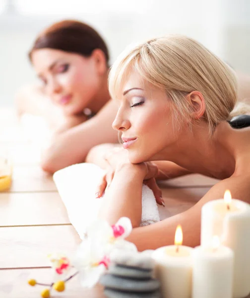 Dos mujeres hermosas jóvenes relajándose y disfrutando en el spa cent —  Fotos de Stock