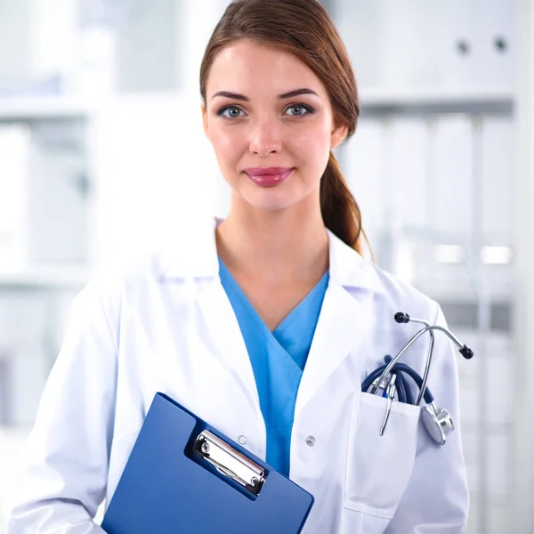 Portrait of young woman doctor with white coat standing in hospital — Stock Photo, Image