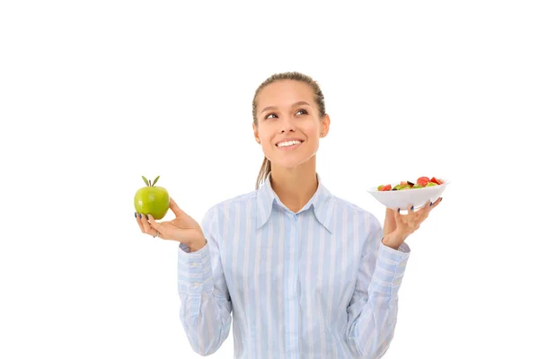 Ritratto di una bella dottoressa che tiene un piatto con verdure fresche e mela verde. Donna medico Foto Stock Royalty Free