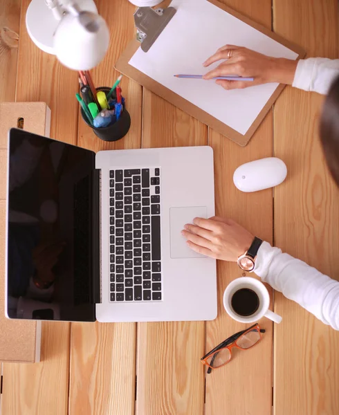 Jonge vrouw werkend zittend aan een bureau. — Stockfoto