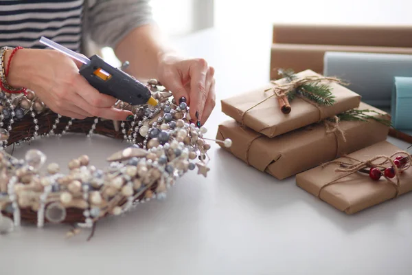 Masada oturan Noel süslemeleri aksesuarları hazırlama kadın