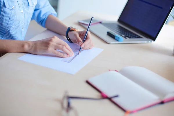 Young woman sitting at office table with laptop. Young woman. Laptop — Stock Photo, Image