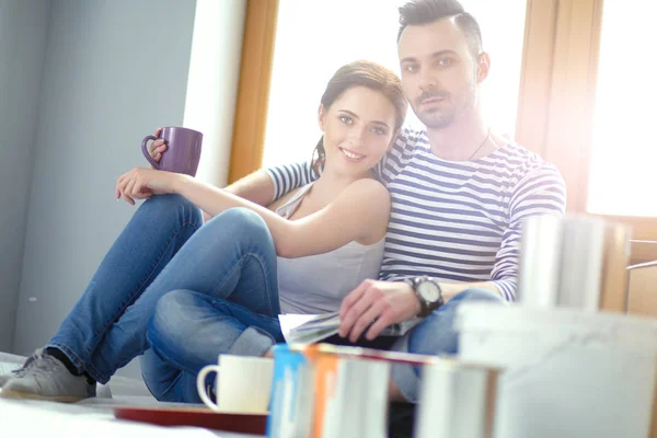 Paar zieht im Haus auf dem Fußboden sitzend ein. Paar — Stockfoto