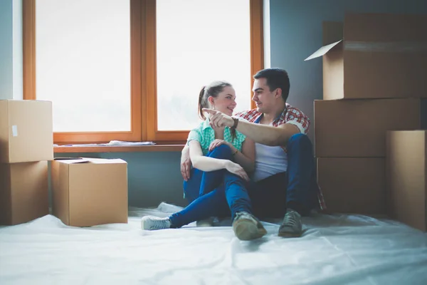 Pareja moviéndose en casa sentada en el suelo. Pareja. — Foto de Stock