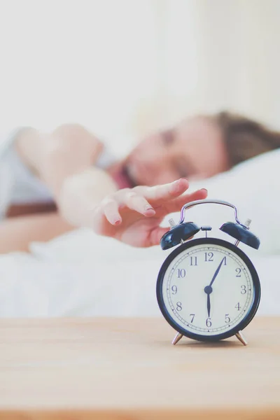 Young sleeping woman and alarm clock in bedroom at home. Young sleeping woman. — Stock Photo, Image