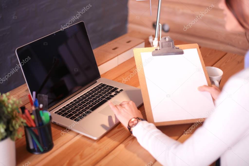 Young female working sitting at a desk.