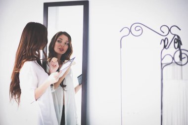 Genç kadın kendini yansıma evde aynaya bakıyorum. Genç kadın.