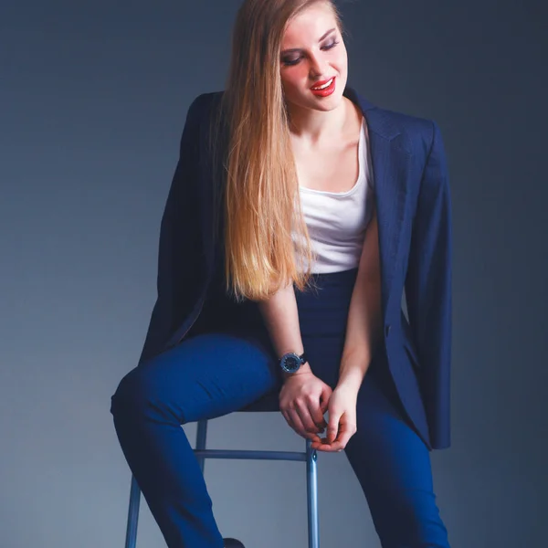Young woman sitting on a chair — Stock Photo, Image