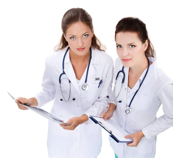 Portrait of two successful female doctors holding a writing pad and x-ray — Stock Photo, Image