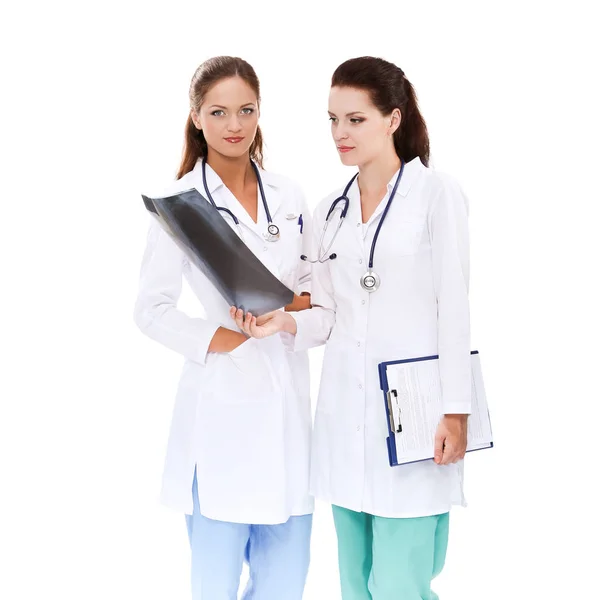 Portrait of two successful female doctors holding a writing pad and x-ray — Stock Photo, Image