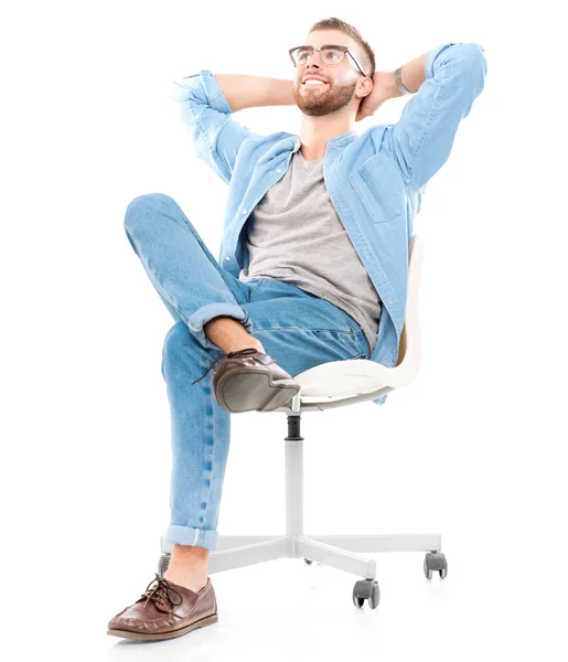 Young man sitting on the chair isolated over white background — Stock Photo, Image