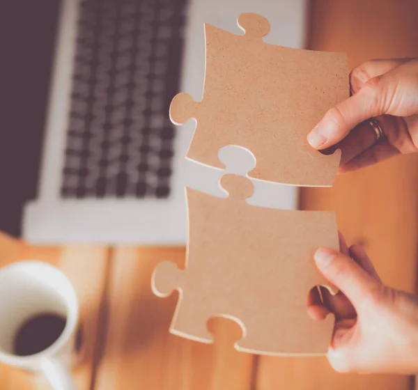 Business woman holding and pointing to a puzzle piece — Stock Photo, Image