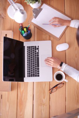 Masada oturan genç bir kadın..