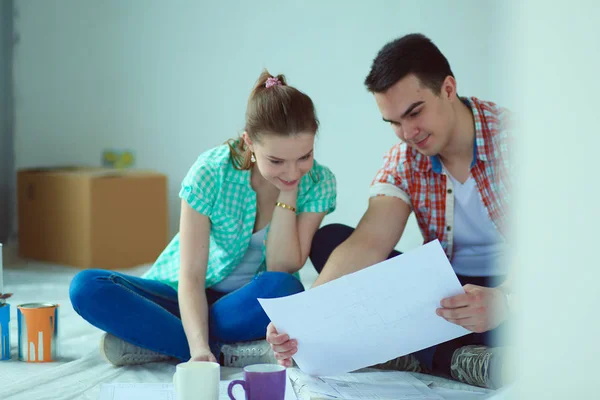 Young couple sitting on floor and calculating about they savings. Young couple — Stock Photo, Image