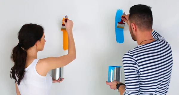 Portrait happy smiling young couple painting interior wall of new house — Stock Photo, Image