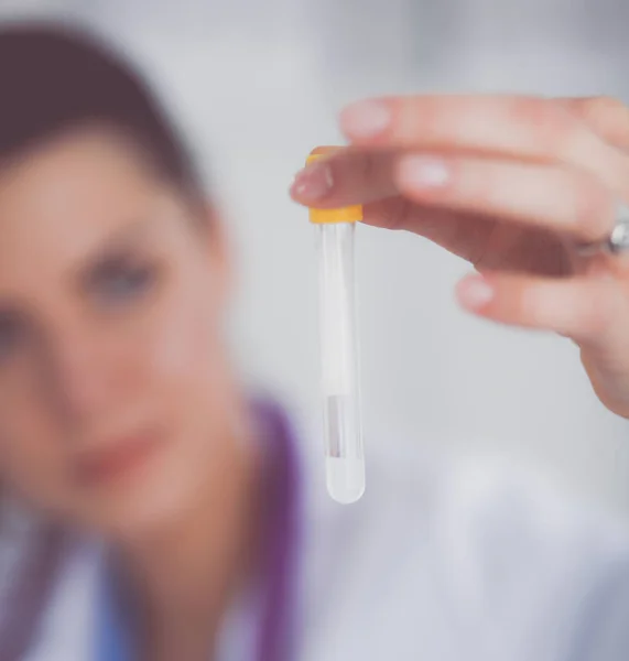 Woman researcher is surrounded by medical vials and flasks, isolated on white background — Stock Photo, Image