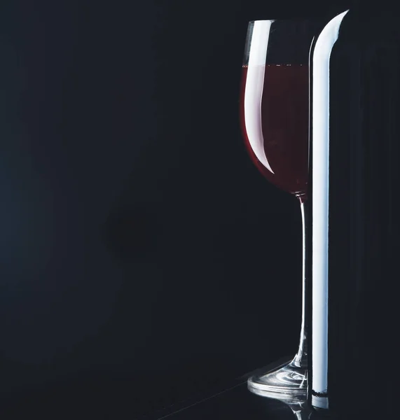 Glass of wine and a bottle on black background — Stock Photo, Image