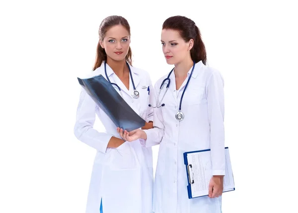 Portrait of two successful female doctors holding a writing pad and x-ray — Stock Photo, Image