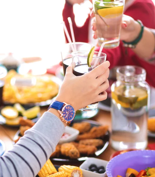 Pessoas com bebidas enquanto se sentam na mesa de jantar — Fotografia de Stock