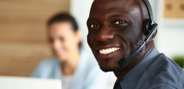 Business people with headsets using computers in office — Stock Photo, Image