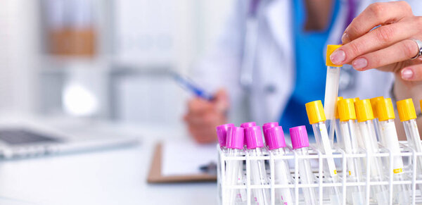 Woman researcher is surrounded by medical vials and flasks, isolated on white background