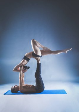 Genç çift Acro yoga mat Studio birlikte uygulamak. Acroyoga. Çift yoga. Ortak yoga.
