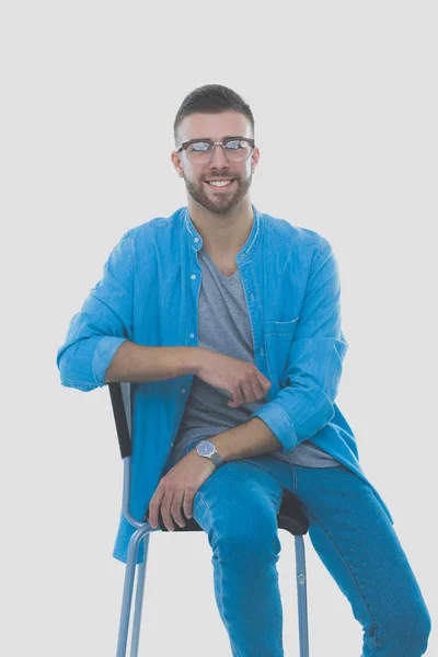 Young man sitting on the chair isolated over white background. Startupper. Young entrepreneur. — Stock Photo, Image