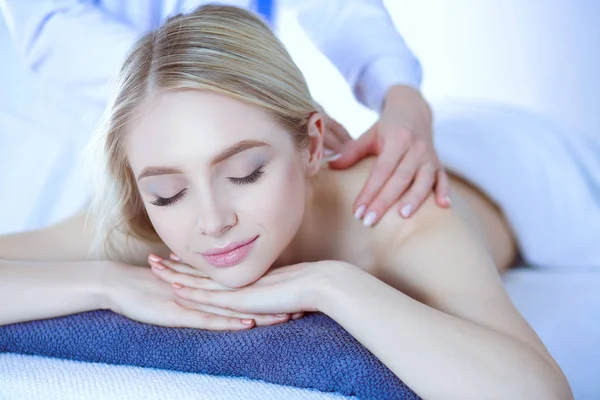 Young woman lying on a massage table,relaxing with eyes closed. Woman. Spa salon — Stock Photo, Image