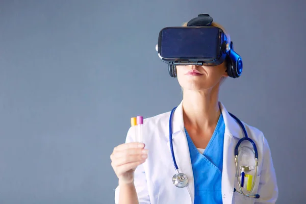 Female doctor wearing virtual reality glasses isolated on white background