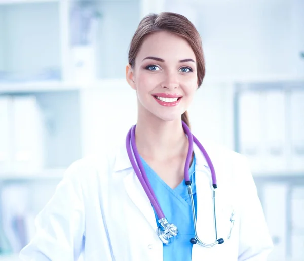 Portrait of young woman doctor with white coat standing in hospital — Stock Photo, Image