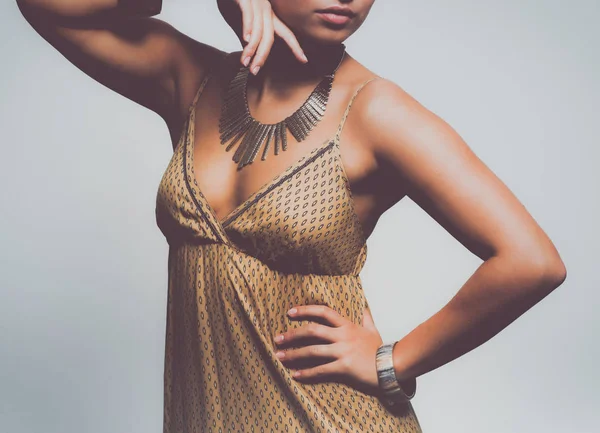 Young woman wearing a beige dress standing — Stock Photo, Image