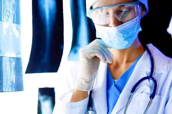 Image of attractive woman doctor looking at x-ray results — Stock Photo, Image