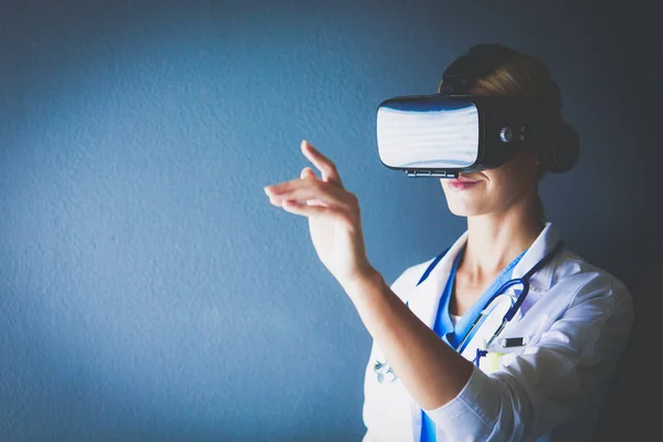 Female doctor wearing virtual reality glasses isolated on white background